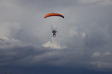 Skydiving. Cloudy sky and a parachute in the sky.
