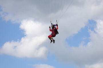 Obraz na płótnie Canvas Skydiving. A pretty girl is landing.