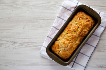 Homemade Cheesy Bread Loaf on a white wooden background, top view. Flat lay, overhead, from above. Copy space.