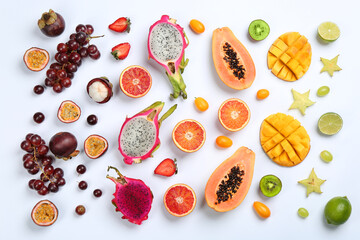 Many different delicious exotic fruits on white background, flat lay