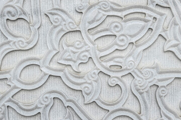 Stone marble wall with carved floral pattern in oriental style
