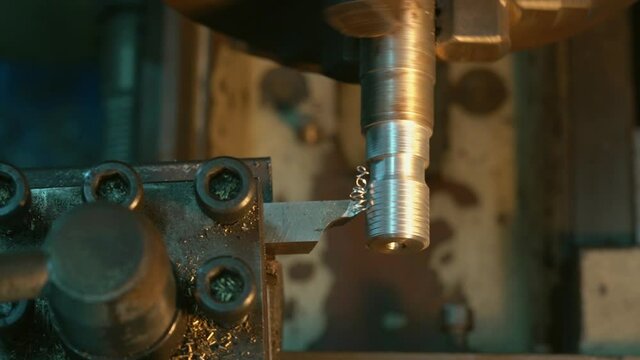 The lathe machine thread cutting the screw metal shaft parts. 