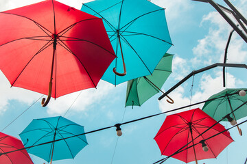 Colorful umbrellas in the sky. Multicolored umbrellas in the sky, creating a summer, art mood on the street