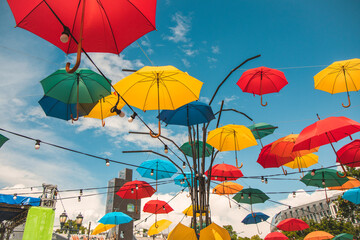 Colorful umbrellas in the sky. Multicolored umbrellas in the sky, creating a summer, art mood on the street
