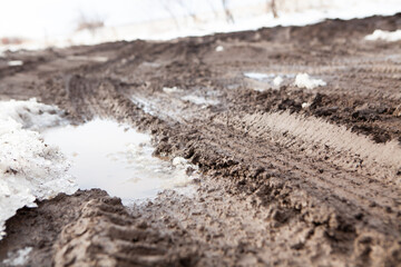 wet dirt road after snow
