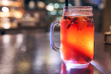 Christmas drink red non-alcoholic mulled wine with a straw on the background of the cafe interior, order for one