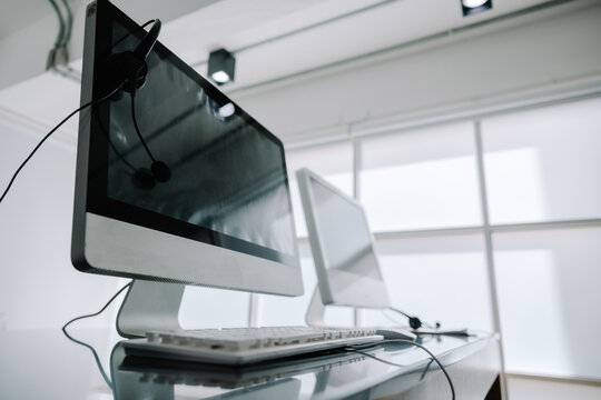 Communication support, call center, and customer service help desk. headset on a laptop computer keyboard.