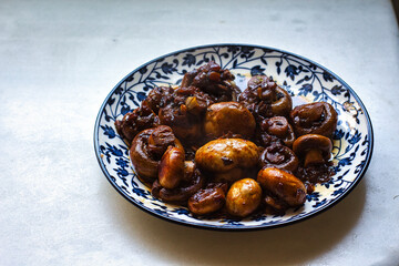 Mushrooms with onion sauce on a blue and white plate