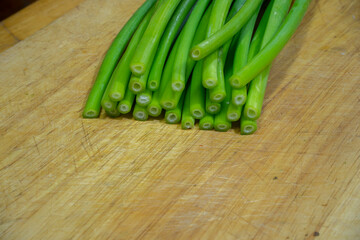 Onion flower, Allium cepa, Welsh Onion, Allium flower on chopping board.