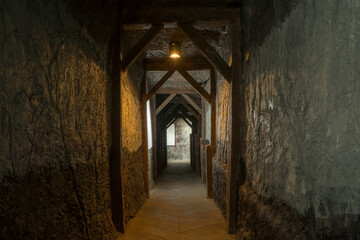 Long lighten tunnel through gypsum mine with wooden beams in north of Thailand.