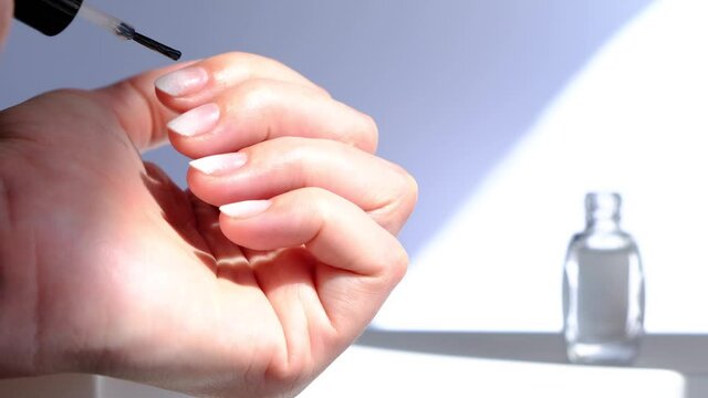 smearing cuticles on fingers with natural cuticle oil, hand and nail care