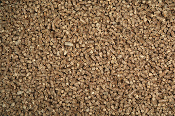 Wood pellet cat litter as background, closeup