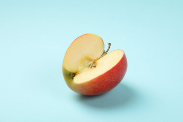 Ripe apple on blue background, close up