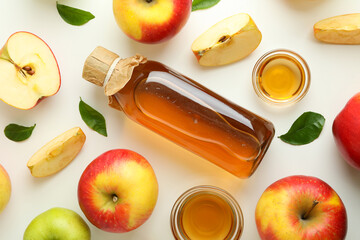 Homemade apple vinegar and ingredients on white background