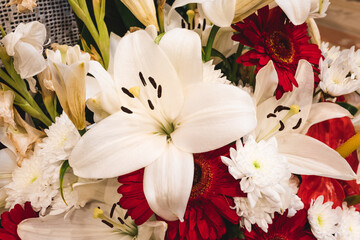 Naklejka na ściany i meble big white lily in a big bouquet of flowers.