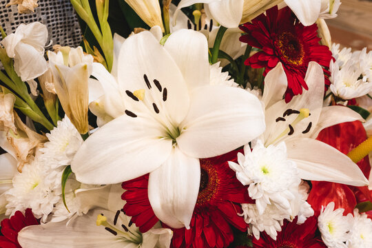 big white lily in a big bouquet of flowers.