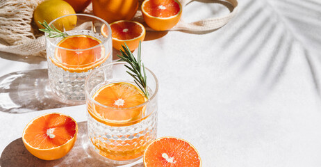 Summer orange cocktails with fresh citrus fruits. Hard seltzer, lemonade, refreshing drinks, low...