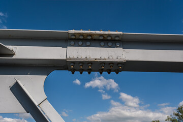 iron steel frame construction of bridge on blue sky background. bridge metal structures, frames,...