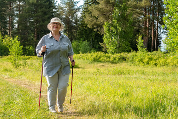 The grandmother is engaged in Scandinavian walking. An elderly woman goes in for sports.