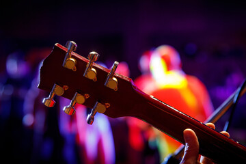 Close-up of guitar tuners during a concert.