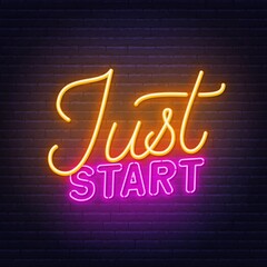 Just start neon sign on brick wall background.