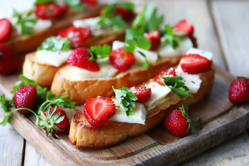 Beautiful bruschetta with strawberries and cheese. Strawberry toast. Healthy summer food.