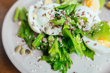 healthy food, dish of green fresh spinach, chicken egg, sesame seeds and balsamic sauce. proper nutrition at home. vegan menu. selective focus