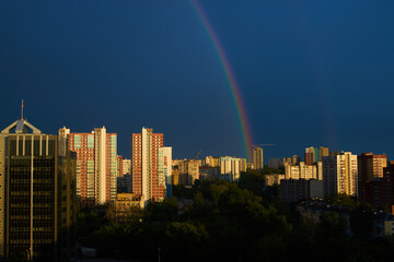 City during sunset with rainbow and blue sky