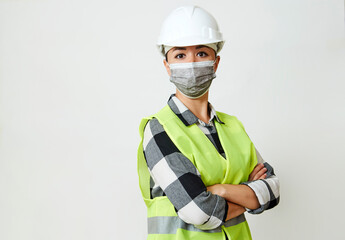 Fototapeta premium Worker woman wearing face mask and protective hard hat.
