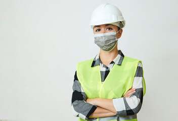 Worker woman wearing face mask and protective hard hat.
