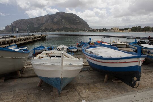 evocative image of fishing boats moored in the harbor in a small fishing village in Sicily, Italy
