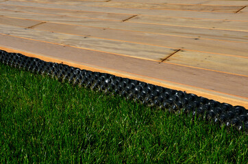 separating the terrace from the lawn using plastic black foil with knobs. prevents grass from...