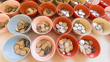 Chachoengsao, Thailand-June, 06, 2021: Thai coin in bowl for donate at Wat Phrong-Akat Chachoengsao Thailand.