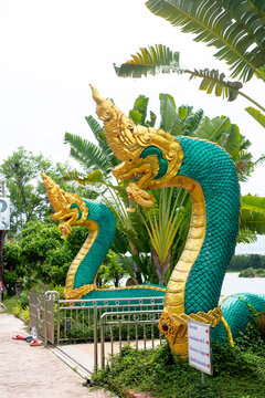 Udon Thani, Thailand - 11 June 2021 : Twin Green Naga statue at  Wat Pa Dong Rai or Wat Santi Wanaram, located at Ban Chiang, Nong Han District, Udon Thani, Thailand.