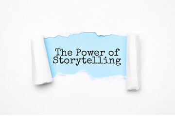 Concept of discovering THE POWER OF STORYTELLING tricks. Uncovered unrolled beige torn paper and search engine optimization abbreviation. - obrazy, fototapety, plakaty