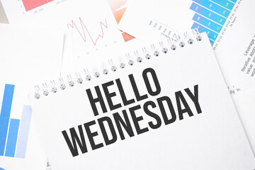 hello Wednesday text on paper on the chart background with pen