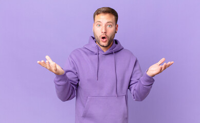 handsome blonde man amazed, shocked and astonished with an unbelievable surprise