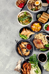 Fototapeta na wymiar Assorted asian dishes and snacks on dark gray background. Traditional food concept.