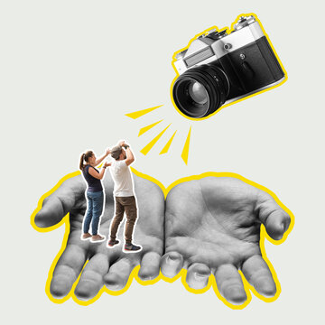 Focus on the male hands. Retro vintage camera and small people. Modern design.