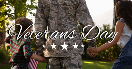 Composition of veterans day text over soldier with his daughter and son holding american flag