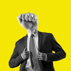 The man in a suit with a head in the form of a fist. Metaphor of an angry boss. Contemporary art...