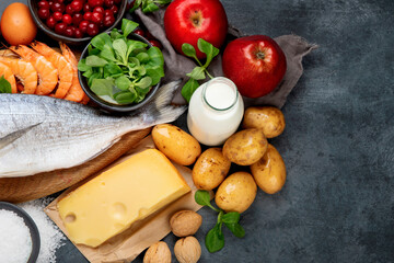 Food high in iodine on dark gray background. Healthy eating concept.