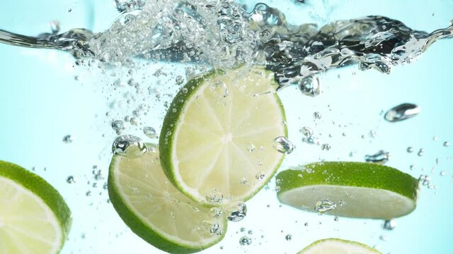 Super slow motion of falling lime slices into splashing water. Filmed on high speed cinema camera, 1000 fps.