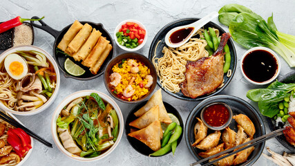 Assorted asian dishes and snacks on dark gray background. Traditional food concept.