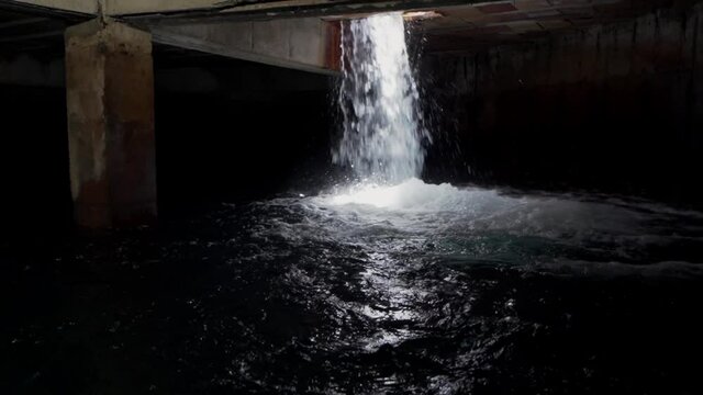 Flooding water from outside. Water filling a tank. Water falling underground. Waterfall flooding a garage. Water storage