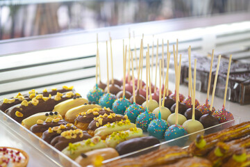 Pastry shop glass display with selection of sweets and cakes. Confectionery shop display...