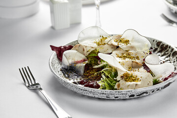 Traditional Italian cuisine Vitello tonnato, marinated veal appetizer with creamy tuna sauce, close-up, light background, copy space