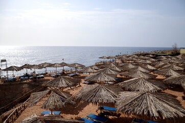 Salah Taher, Qesm Sharm Ash Sheikh, South Sinai Governorate, Egypt/ 04.22.2021/ beach umbrellas on Reef Beach on Red sea Egypt