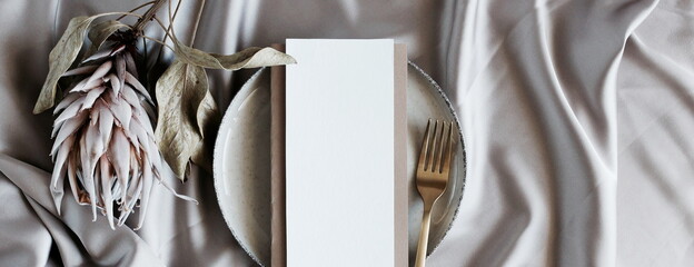 Menu card mockup on empty modern minimal table place setting neutral beige color banner.  Space for text. Scandinavian style.