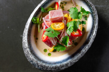 tuna tartare with tomato lemon onion chili and fresh herbs in a crockery